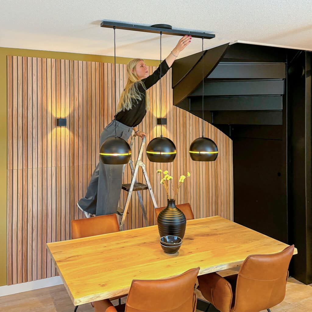 Lightswing® Zero Black with three pendant lights above dining table in modern dining room during installation