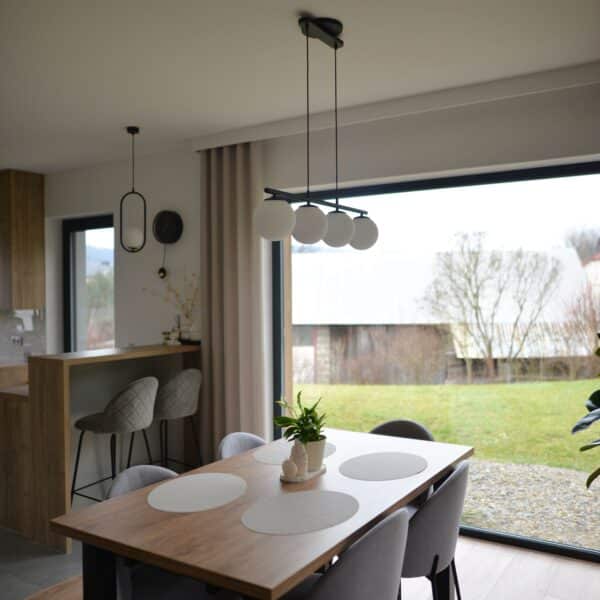 Lightswing® Zero Matt Black with three pendant lights above dining table in modern dining area