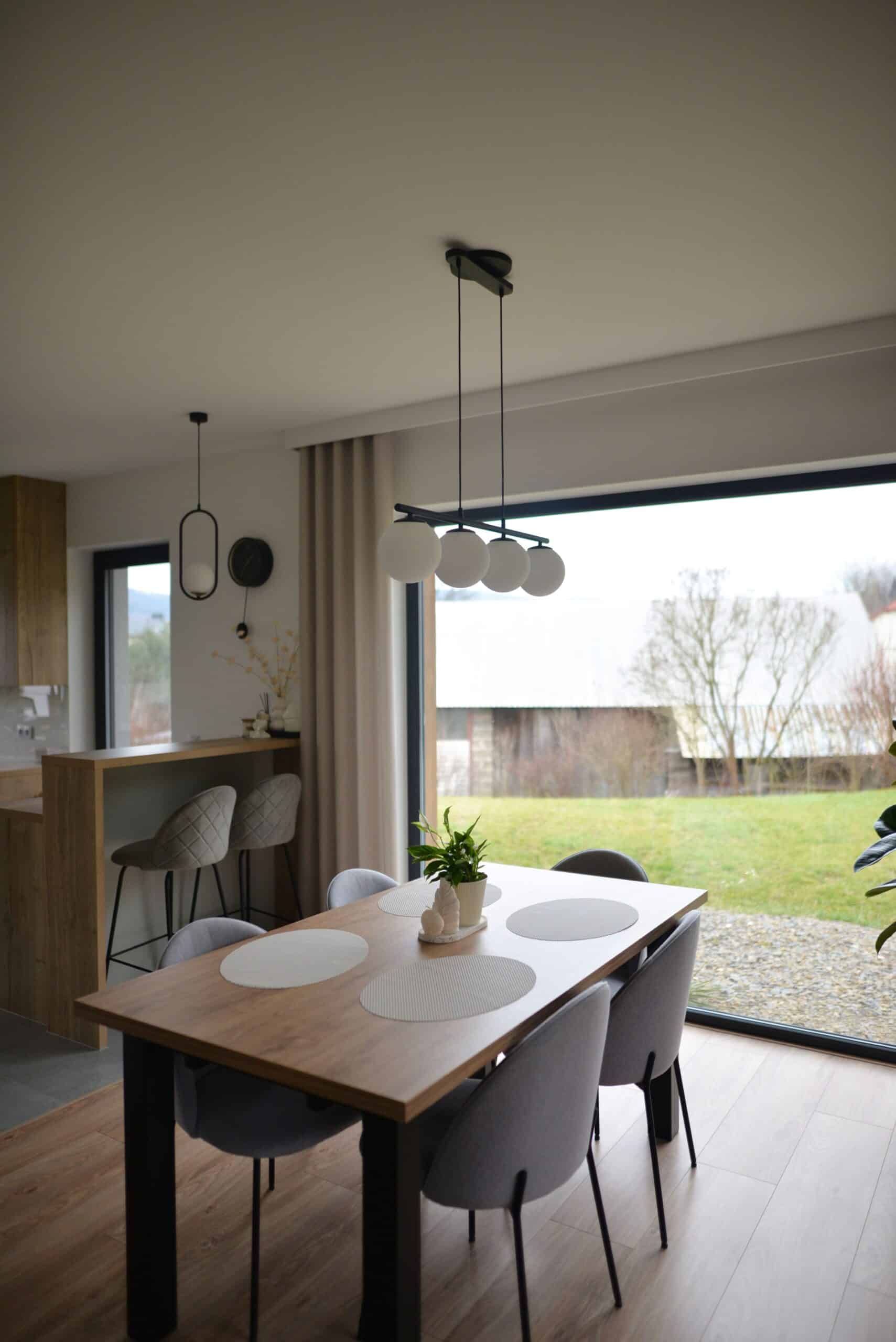 Lightswing® Zero Matt Black with three pendant lights above dining table in modern dining area