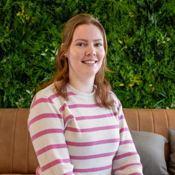Portrait of employee in office with green wall and Bright Solutions interior