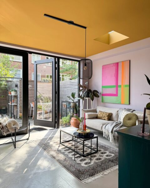 Lightswing® Single Matt Black with one pendant light in colorful modern living room with yellow ceiling