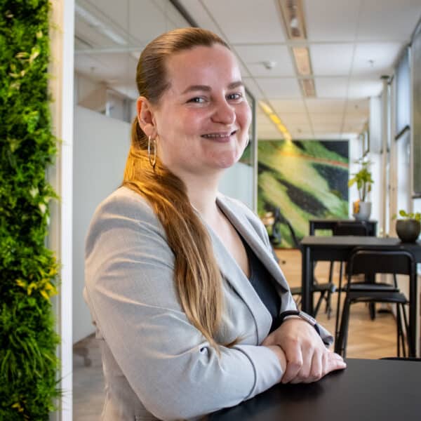 Portrait of employee in office with green wall and Bright Solutions interior